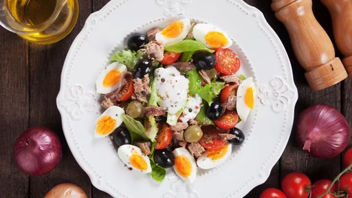 Salad Nicoise with boiled eggs, tuna, anchovy and olives