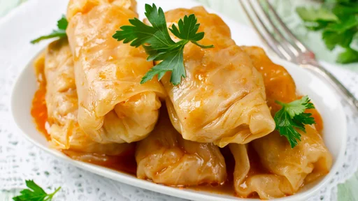 Stuffed cabbage rolls with rice and meat in tomato sauce