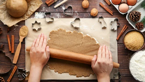 Baking christmas cookies on brown wooden table
