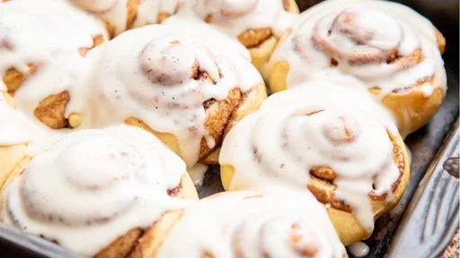 Homemade cinnamon buns in glaze, copy space, top view.