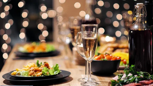 Festive table setting. Food and drinks, plates and glasses. Evening lights and candles. New Year's Eve Christmas Dinner. (Festive table setting. Food and drinks, plates and glasses. Evening lights and candles. New Year's Eve Christmas Dinner., ASCII,