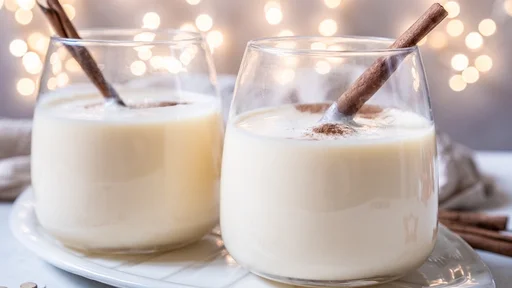 Traditional Christmas drink eggnog with cinnamon and Gingerbread man cookies