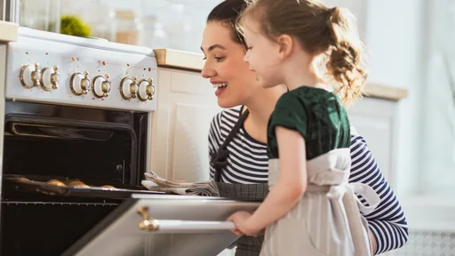 Happy loving family are preparing bakery together. Mother and child daughter girl are cooking cookies and having fun in the kitchen. Homemade food and little helper.                 (Happy loving family are preparing bakery together.