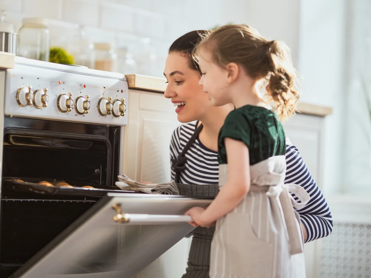 Happy loving family are preparing bakery together. Mother and child daughter girl are cooking cookies and having fun in the kitchen. Homemade food and little helper. (Happy loving family are preparing bakery together.