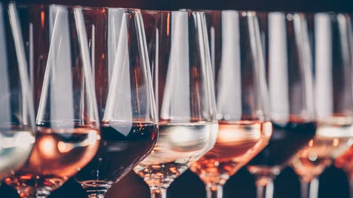 Wine glasses in a row. Buffet table celebration of wine tasting. Nightlife, celebration and entertainment concept. Horizontal, cold toned image (Wine glasses in a row. Buffet table celebration of wine tasting. Nightlife, celebration and entertainment