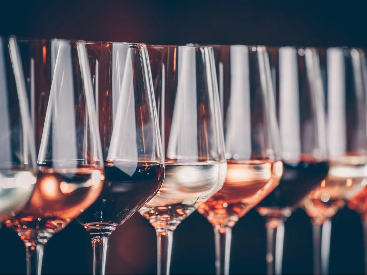 Wine glasses in a row. Buffet table celebration of wine tasting. Nightlife, celebration and entertainment concept. Horizontal, cold toned image (Wine glasses in a row. Buffet table celebration of wine tasting. Nightlife, celebration and entertainment
