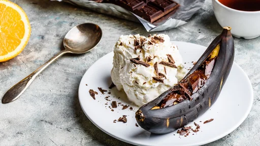 Sweet dessert. Grilled banana with dark chocolate, citrus juice and vanilla ice cream.