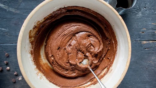 mixing bowl of chocolate dough batter flat lay