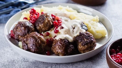 Homemade beef and pork meatballs with mashed potatoes and lingonberry sauce on a gray stone concrete background table. Lunch Dinner Food Concept (Homemade beef and pork meatballs with mashed potatoes and lingonberry sauce on a gray stone concrete back