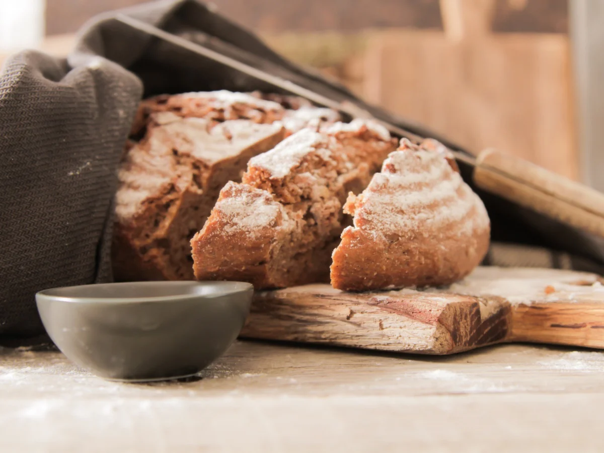 Sliced bread Ciabatta and rosemary on wooden background
