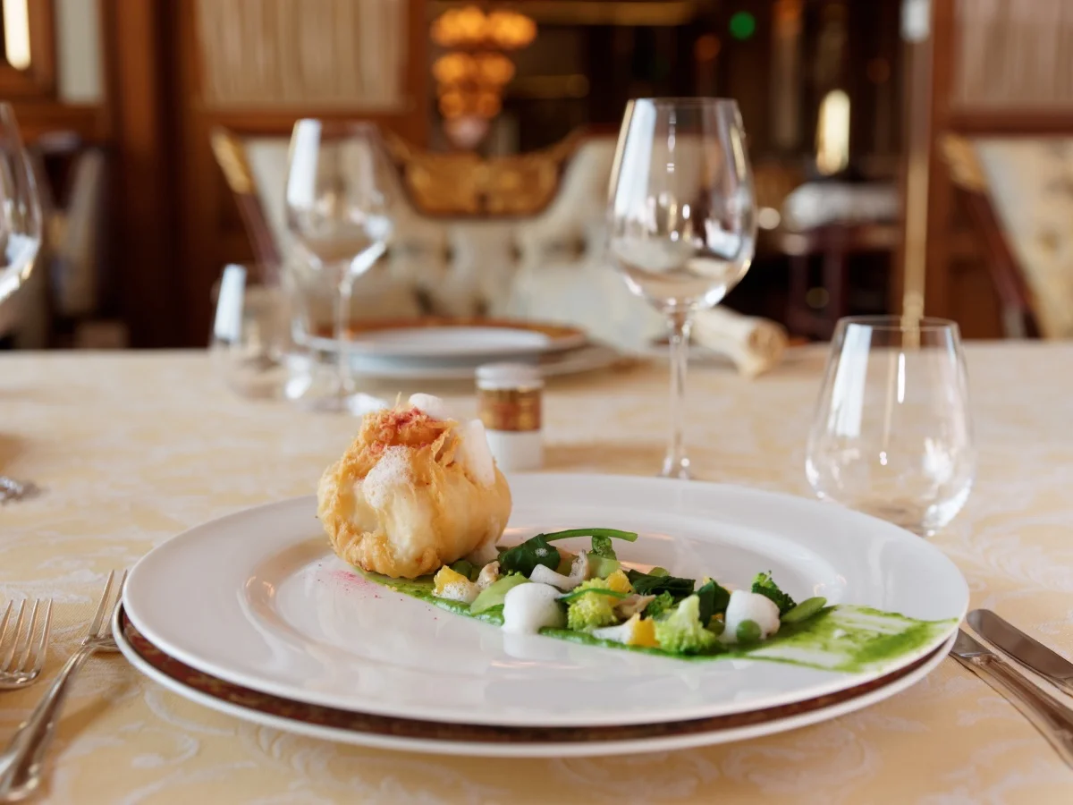 Creative fish dish in expensive restaurant, classic place setting