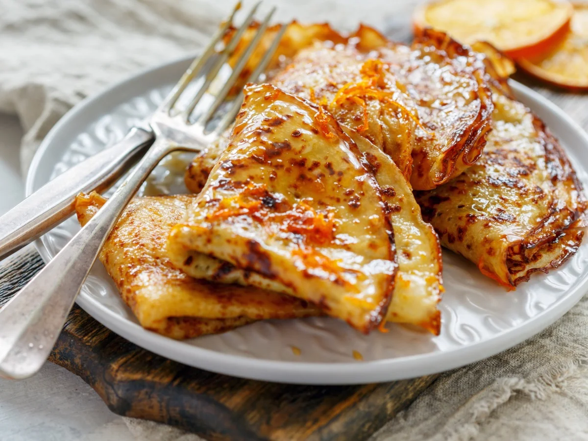 Crepe Suzette with orange sauce for a delicious breakfast, selective focus.