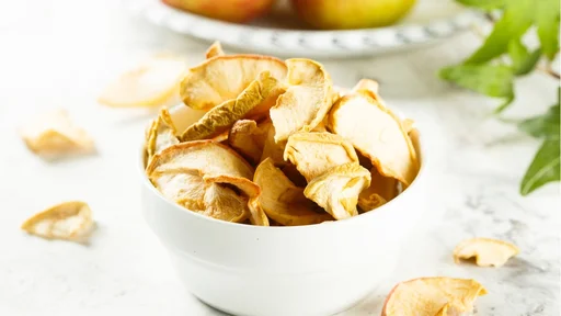 Organic apple chips in white bowl