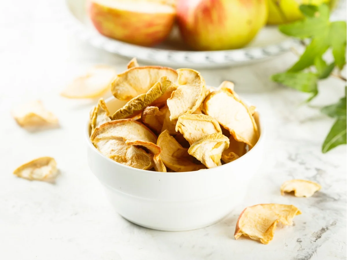 Organic apple chips in white bowl