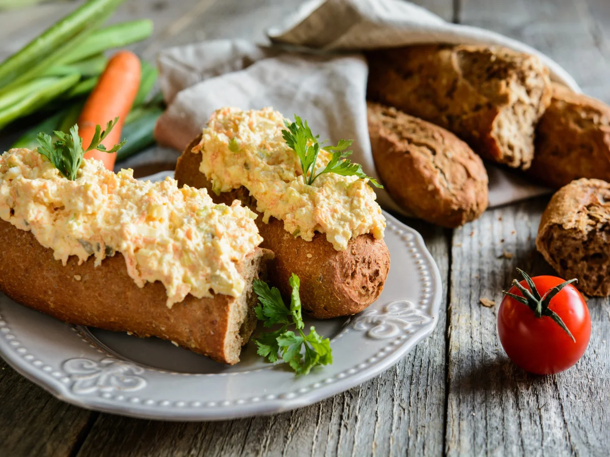 Whole wheat baguette with curd spread, eggs, carrot, green onion, pickled cucumber and mayonnaise