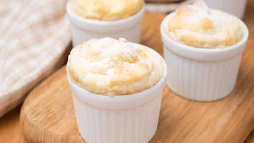peach souffle in the portioned form on a wooden board, close-up