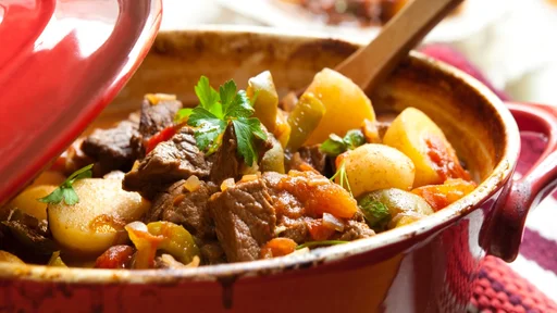 Traditional goulash or beef stew, in red crock pot, ready to serve. Shallow DOF. More beef images: