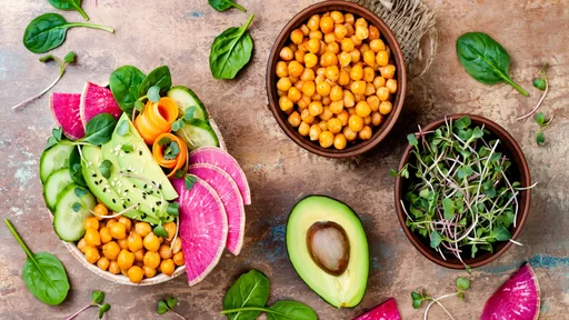 Vegan, detox Buddha bowl recipe with avocado, carrots, spinach, chickpeas and radishes. Top view, flat lay, copy space