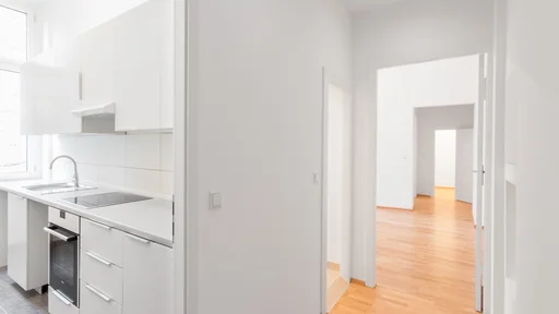 empty flat, white kitchen and wooden floor