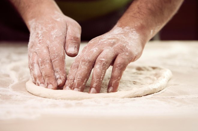 hands knead the dough (Bot Mi) for pizza making