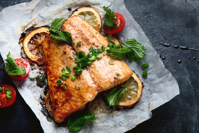 Grilled Salmon with lemon and herb. Healthy diet eating. Top view with copy space.