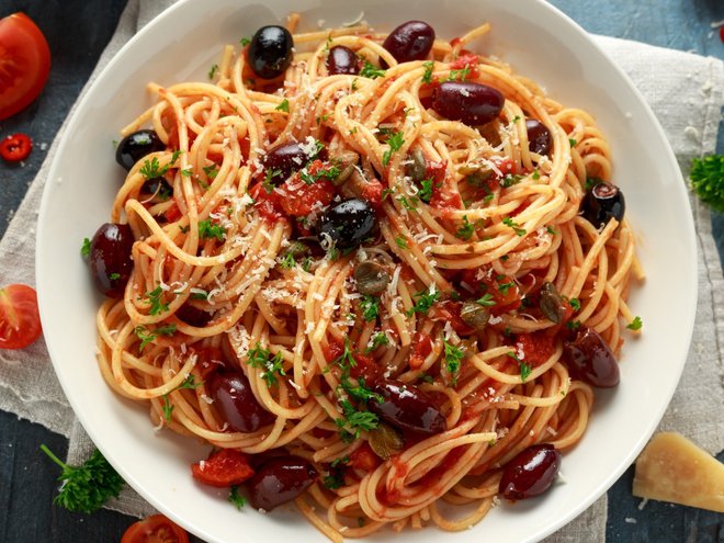 Pasta Alla Puttanesca with garlic, olives, capers, tomato and anchois fish.